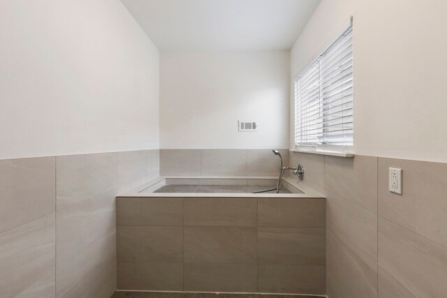 bathroom featuring tile walls