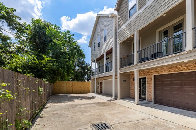 exterior space featuring a balcony and a garage