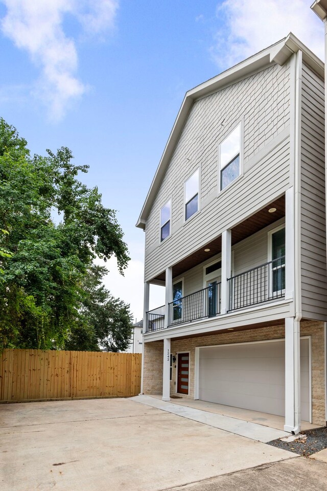 view of front of home featuring a balcony and a garage