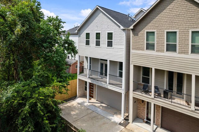 view of front facade featuring a garage and a balcony