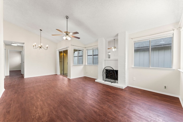 unfurnished living room with a fireplace, a textured ceiling, vaulted ceiling, and dark hardwood / wood-style flooring