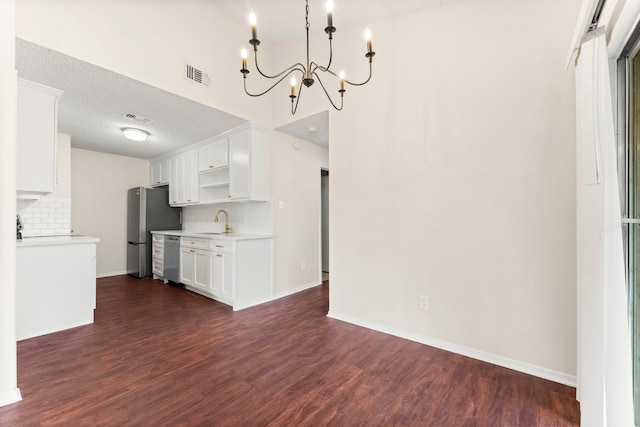 kitchen with tasteful backsplash, sink, a textured ceiling, white cabinets, and dark wood-type flooring