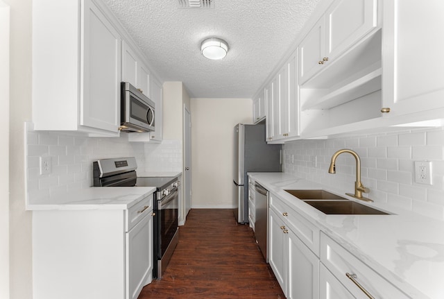 kitchen with sink, white cabinets, dark wood-type flooring, and stainless steel appliances