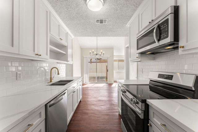 kitchen featuring stainless steel appliances, dark hardwood / wood-style flooring, and white cabinets