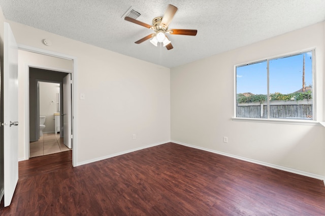 unfurnished room with dark wood-type flooring, a textured ceiling, and ceiling fan