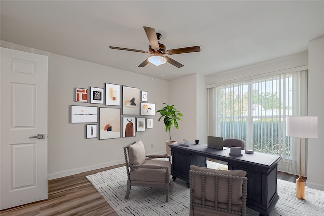 home office with ceiling fan and hardwood / wood-style floors