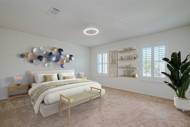 bedroom featuring multiple windows and light colored carpet