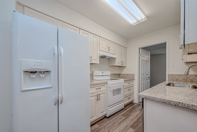 kitchen with light hardwood / wood-style flooring, white cabinets, sink, and white appliances