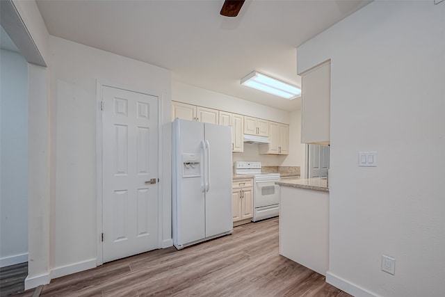 kitchen featuring white appliances and light hardwood / wood-style floors