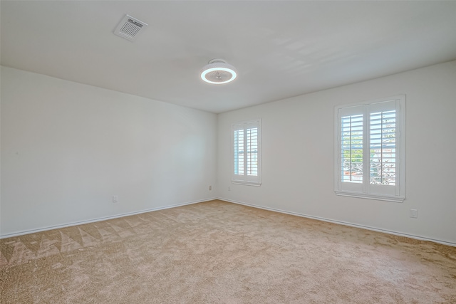 carpeted spare room with a healthy amount of sunlight