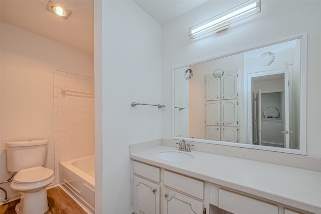 full bathroom featuring vanity, toilet, shower / tub combination, and hardwood / wood-style floors