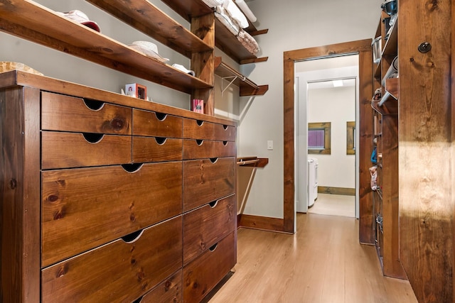 walk in closet featuring washer / dryer and light wood-type flooring