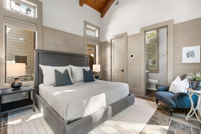 bedroom featuring connected bathroom, high vaulted ceiling, beam ceiling, and wooden ceiling