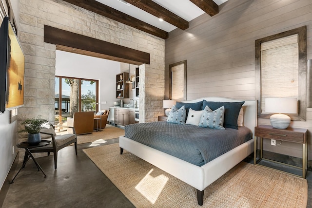 bedroom with wooden walls, beamed ceiling, and a high ceiling