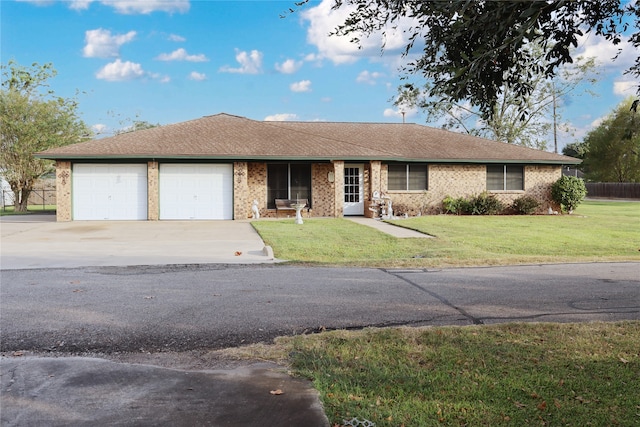 ranch-style home featuring a front lawn and a garage