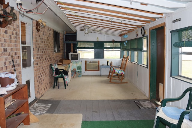 unfurnished sunroom featuring vaulted ceiling and plenty of natural light