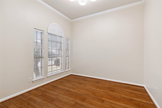 empty room with crown molding, a textured ceiling, and hardwood / wood-style floors