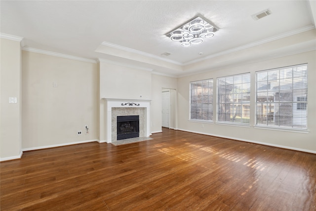 unfurnished living room featuring ornamental molding and wood-type flooring