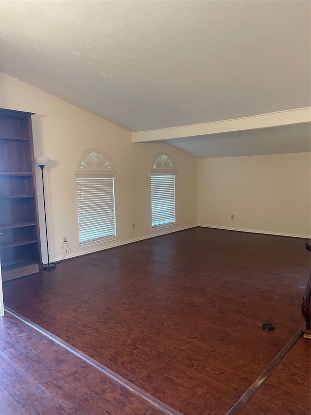 spare room with dark wood-type flooring