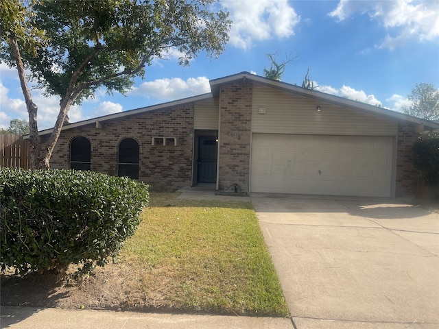 single story home featuring a front yard and a garage