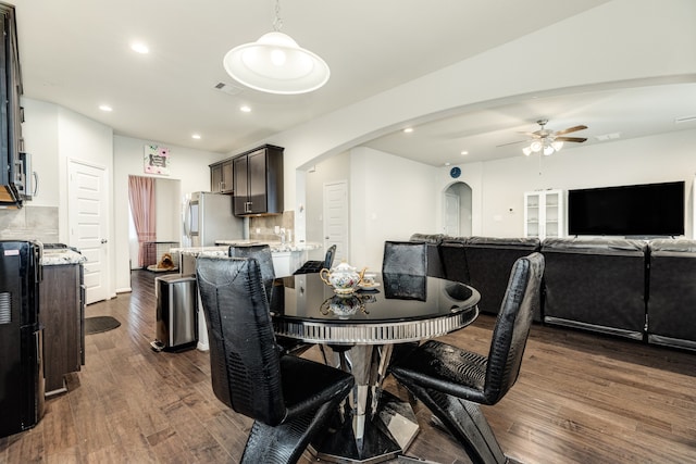 dining area featuring dark wood-type flooring and ceiling fan