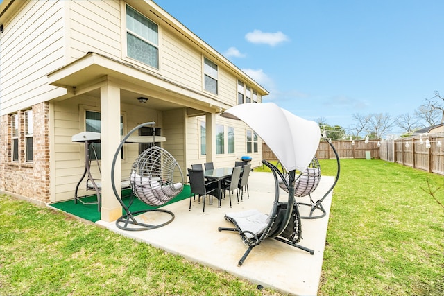 rear view of property featuring a patio and a lawn