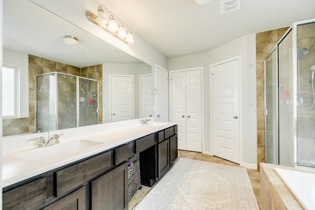 bathroom with vanity, independent shower and bath, and tile patterned flooring