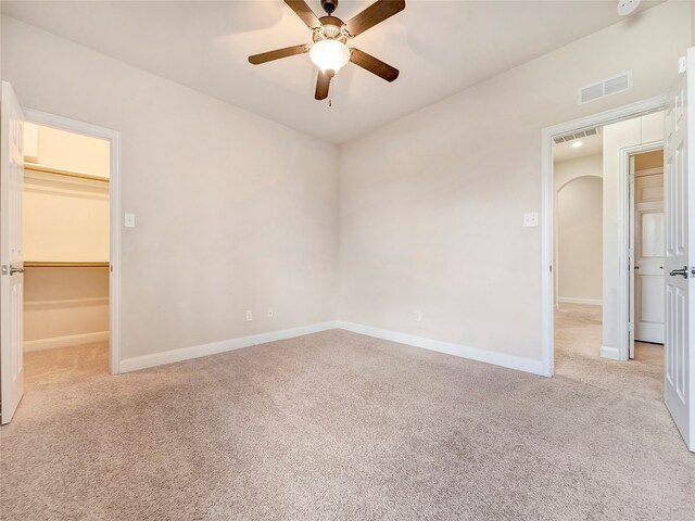 carpeted spare room with ceiling fan