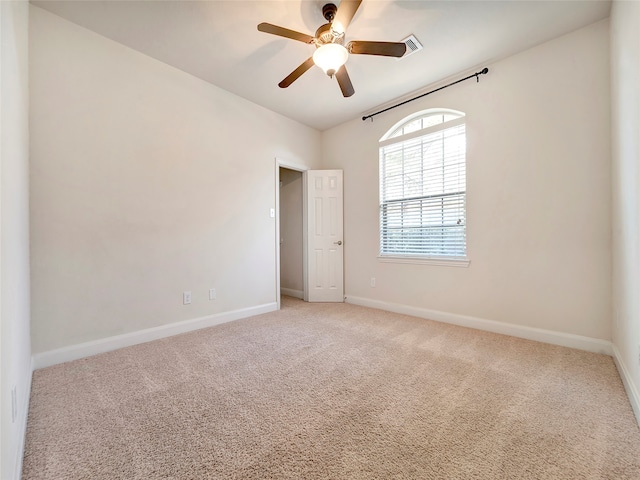 spare room featuring carpet flooring and ceiling fan