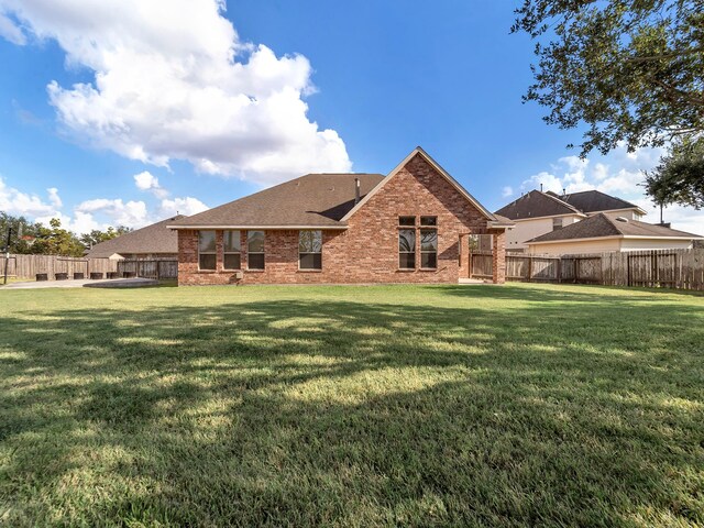 back of house with a yard