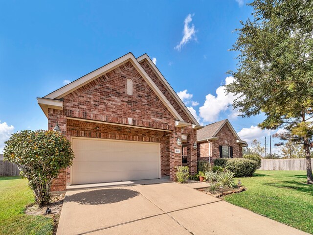 view of front of property with a garage and a front lawn