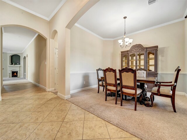 dining space featuring light tile patterned flooring, a chandelier, and ornamental molding