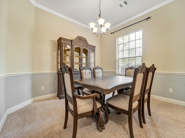 carpeted dining room featuring ornamental molding and an inviting chandelier