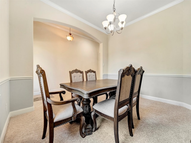 dining area featuring light colored carpet, an inviting chandelier, and ornamental molding