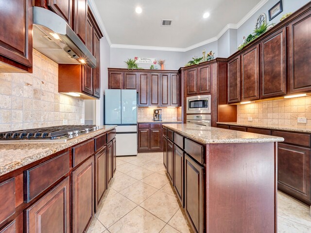 kitchen with stainless steel appliances, a center island, decorative backsplash, ornamental molding, and ventilation hood