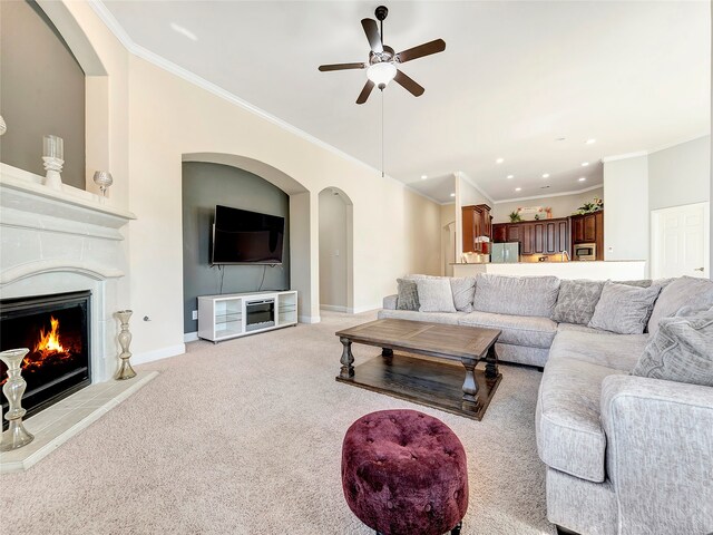 carpeted living room featuring ceiling fan and crown molding