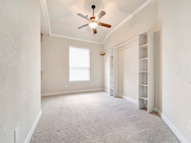 unfurnished bedroom with vaulted ceiling, light carpet, ornamental molding, ceiling fan, and a closet