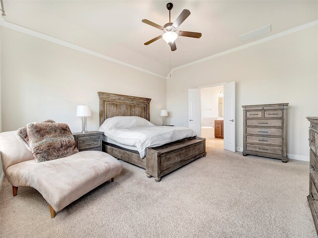 bedroom with crown molding, light carpet, ceiling fan, and ensuite bath