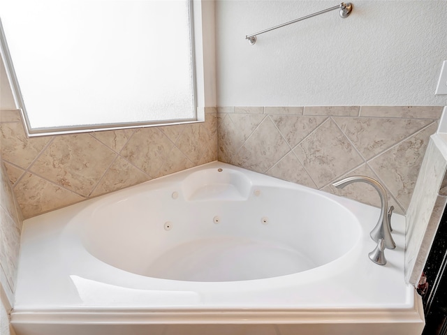 bathroom with a bathing tub and plenty of natural light