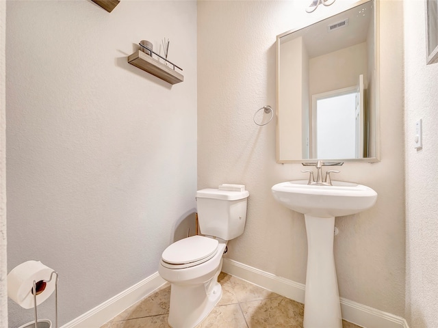 bathroom featuring tile patterned floors and toilet