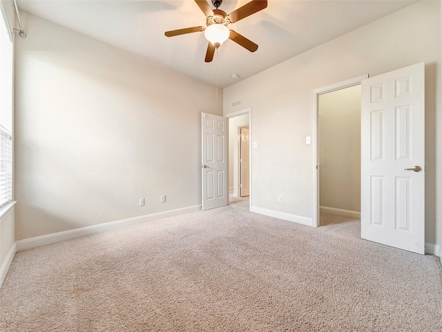 unfurnished bedroom with light carpet and ceiling fan