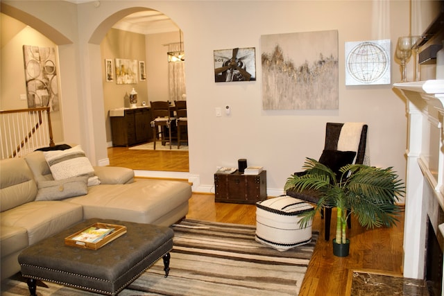 living room with light hardwood / wood-style floors and ornamental molding