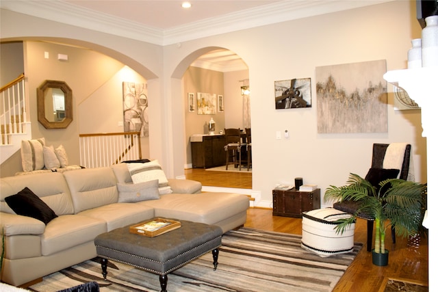 living room with hardwood / wood-style floors and crown molding