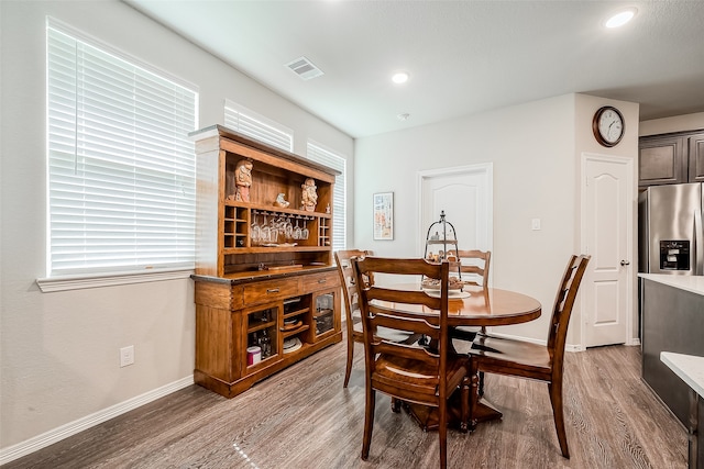 dining space with wood-type flooring