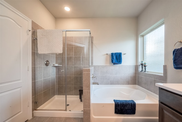 bathroom with vanity, tile patterned floors, and shower with separate bathtub