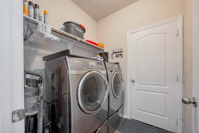 laundry area featuring a textured ceiling and separate washer and dryer