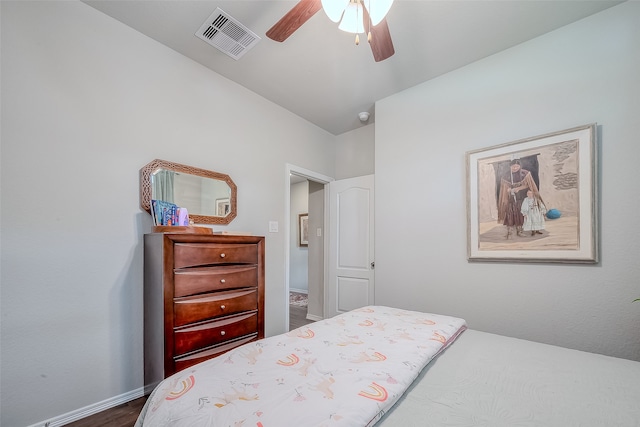 bedroom with ceiling fan and dark hardwood / wood-style flooring