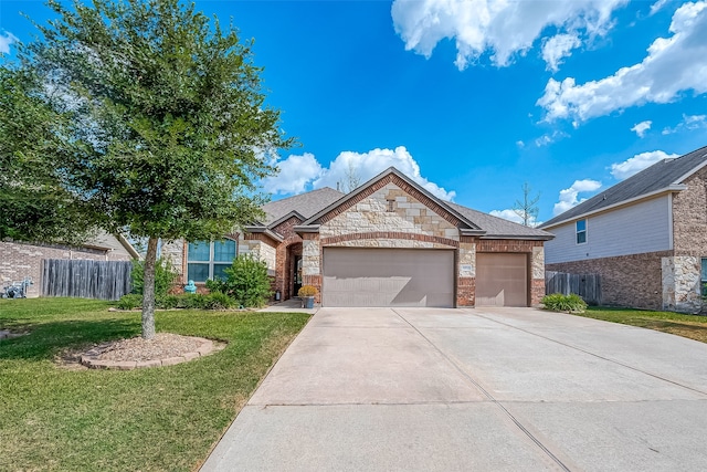 view of front of property with a front yard and a garage