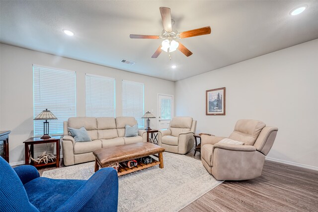 living room featuring ceiling fan and hardwood / wood-style floors