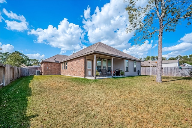 back of house featuring a yard, a patio, and central AC unit